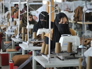Women in burkas working in a textile factory